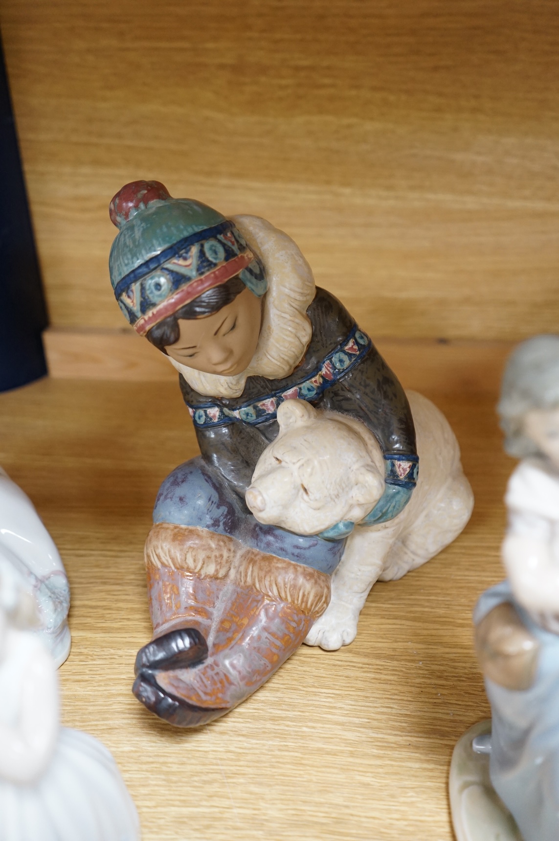 A collection of Lladro to including an eskimo and polar bear group, 23cm high (9)